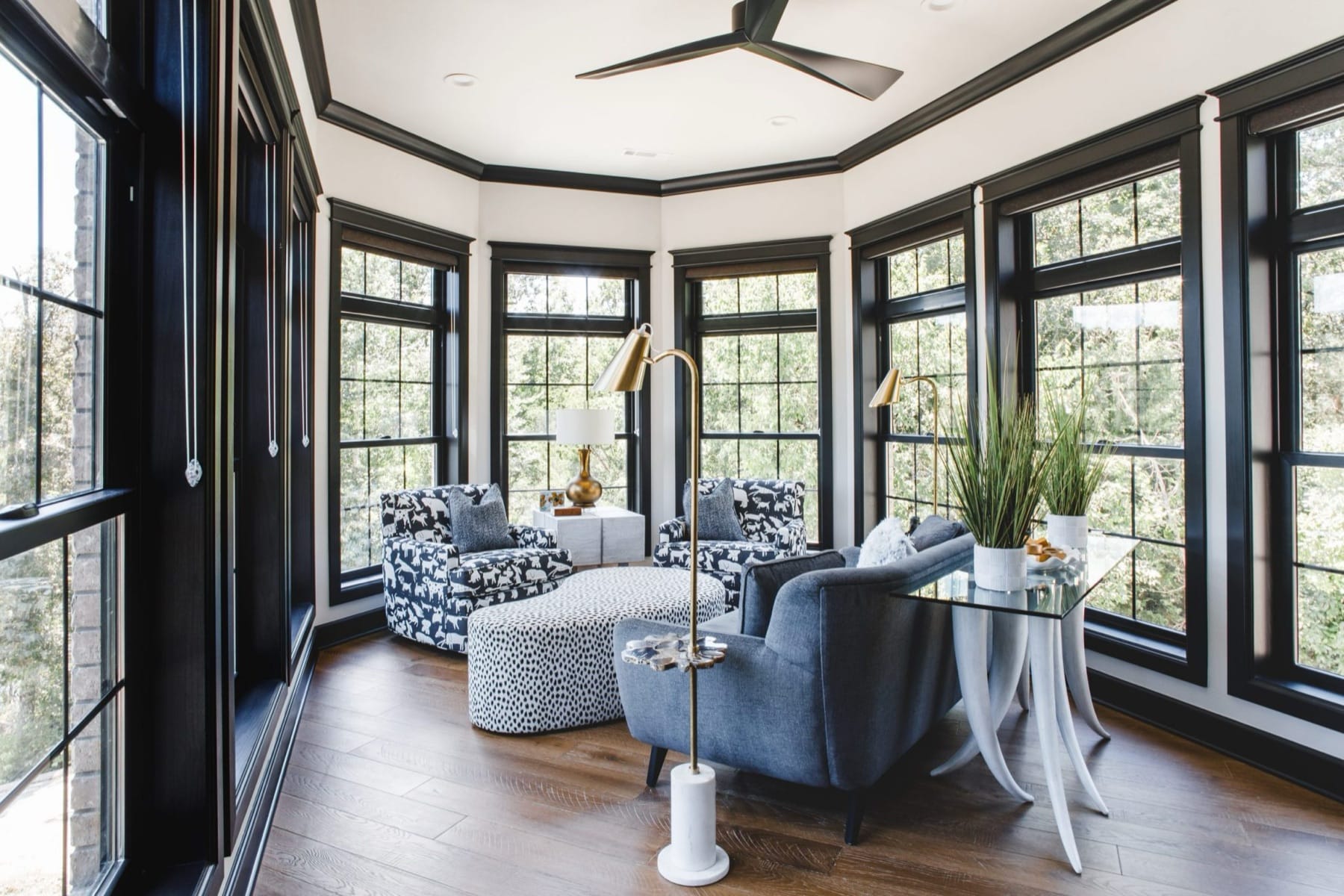 Custom sunroom with bay windows and designer furnishings